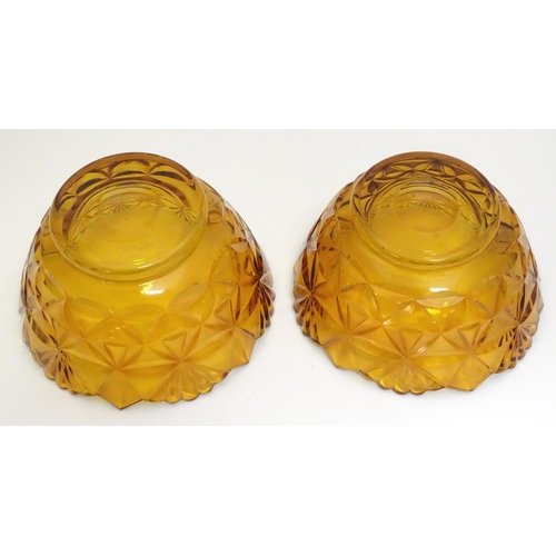 227 - Two amber glass bowls with cut decoration. approx. 6