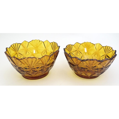 227 - Two amber glass bowls with cut decoration. approx. 6