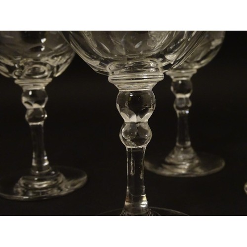 230 - Georgian glasses: a set of four facet cut pedestal glasses with ground pontil scars under, each 4 3/... 