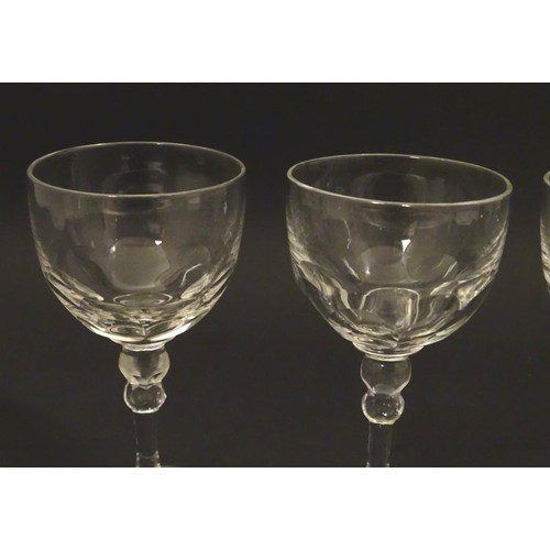 230 - Georgian glasses: a set of four facet cut pedestal glasses with ground pontil scars under, each 4 3/... 