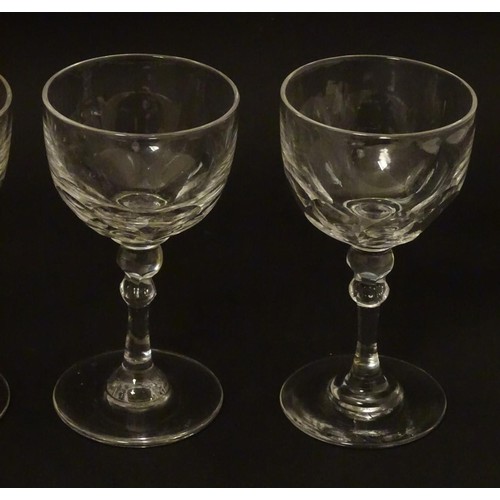 230 - Georgian glasses: a set of four facet cut pedestal glasses with ground pontil scars under, each 4 3/... 