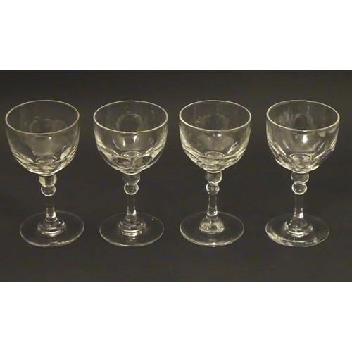 230 - Georgian glasses: a set of four facet cut pedestal glasses with ground pontil scars under, each 4 3/... 