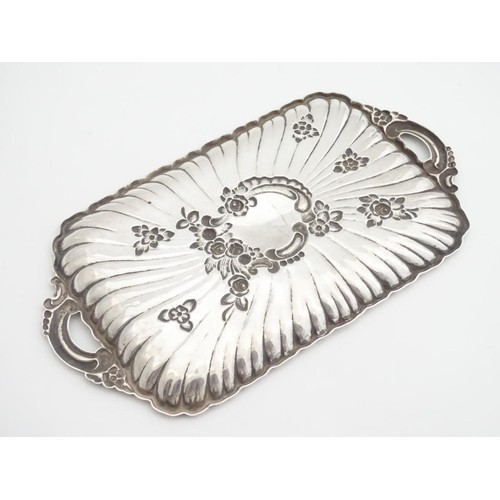 232 - A late 19thC Spanish silver dressing table tray with embossed decoration. 6 1/4