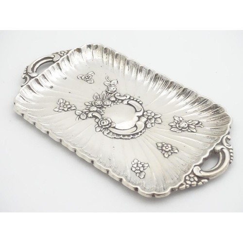 232 - A late 19thC Spanish silver dressing table tray with embossed decoration. 6 1/4