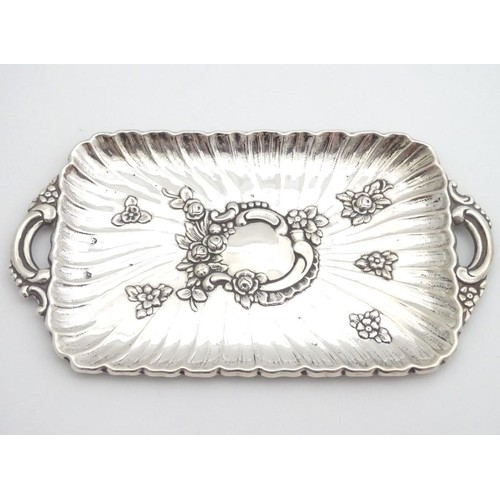 232 - A late 19thC Spanish silver dressing table tray with embossed decoration. 6 1/4