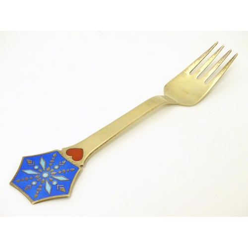 374 - A Danish sterling silver gilt and enamel 1976 Christmas fork with Snow Crystal design. Maker A. Mich... 