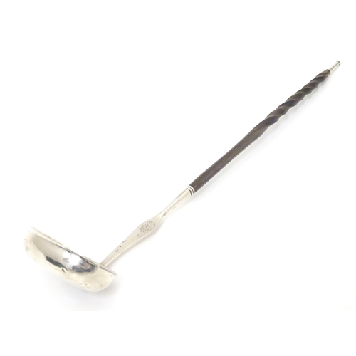 435 - A Scottish silver punch ladle with twist handle.  13 1/2