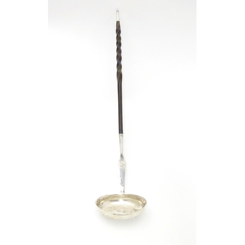 435 - A Scottish silver punch ladle with twist handle.  13 1/2