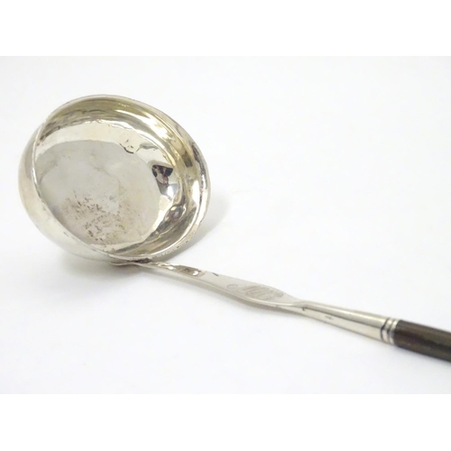 435 - A Scottish silver punch ladle with twist handle.  13 1/2