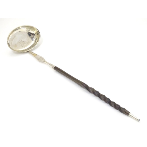 435 - A Scottish silver punch ladle with twist handle.  13 1/2