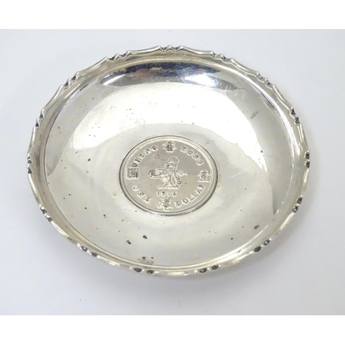 452 - A Chinese Export silver pin dish of circular form with inset  QEII Hong Kong Dollar to centre.  3 1/... 