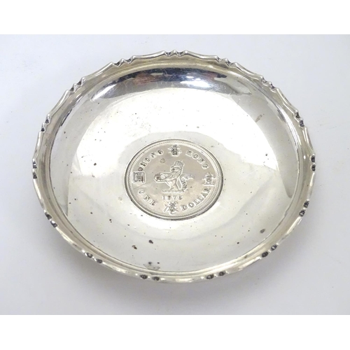 452 - A Chinese Export silver pin dish of circular form with inset  QEII Hong Kong Dollar to centre.  3 1/... 