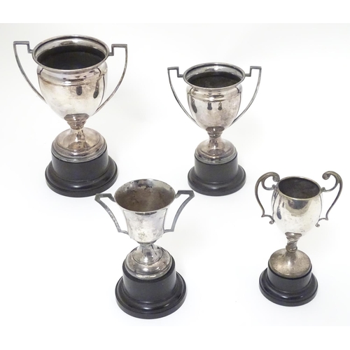 479 - 4 assorted silver plate trophy cups. The largest approx 7