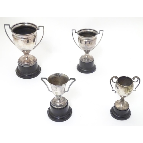 479 - 4 assorted silver plate trophy cups. The largest approx 7