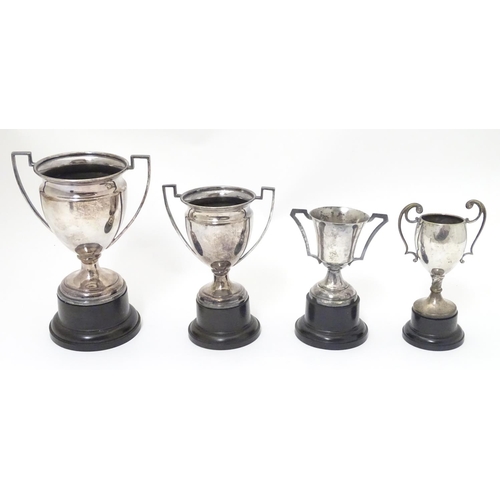 479 - 4 assorted silver plate trophy cups. The largest approx 7