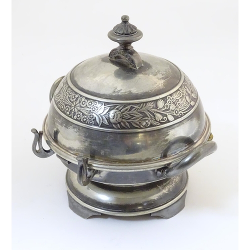 480 - An American silver plated twin-handled butter dish with embossed foliate decoration, the hinged lid ... 