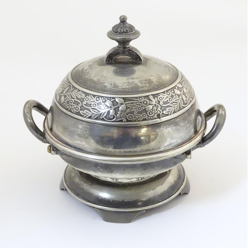 480 - An American silver plated twin-handled butter dish with embossed foliate decoration, the hinged lid ... 