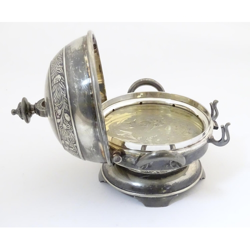 480 - An American silver plated twin-handled butter dish with embossed foliate decoration, the hinged lid ... 