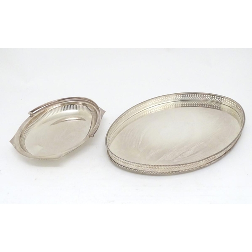 500 - A silver plated oval tray with galleried side together with a cake basket with swing over handle. Th... 