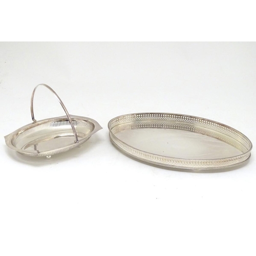 500 - A silver plated oval tray with galleried side together with a cake basket with swing over handle. Th... 