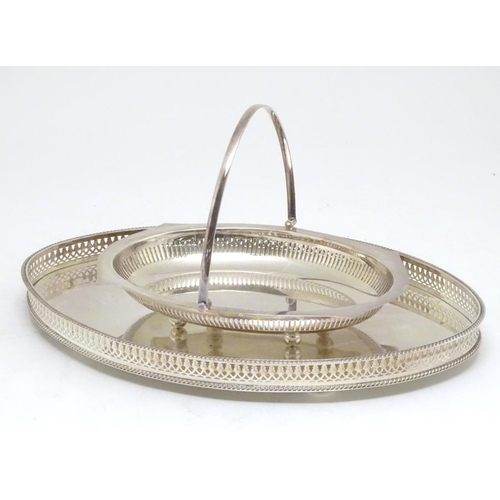 500 - A silver plated oval tray with galleried side together with a cake basket with swing over handle. Th... 