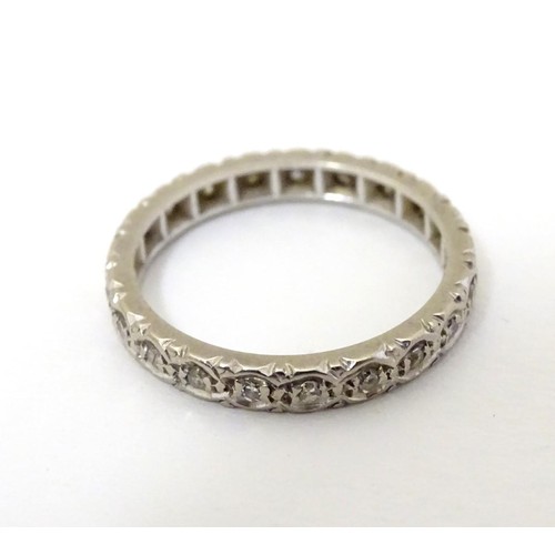 508 - A white gold eternity ring set with band of diamonds. Ring size approx M 1/2