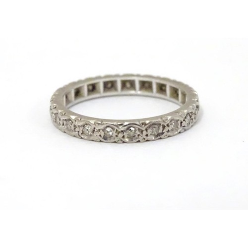 508 - A white gold eternity ring set with band of diamonds. Ring size approx M 1/2