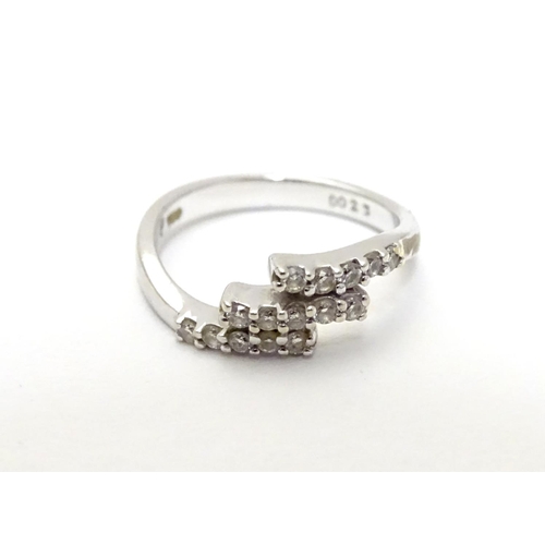 525 - An 18ct white gold ring set with three bands of 5 white stones. Ring size approx H