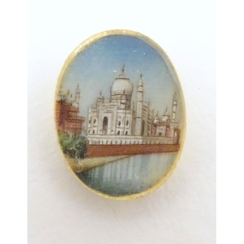 549 - A small cabochon depicting a miniature hand painted scene depicting the Taj Mahal. Approx. 3/4