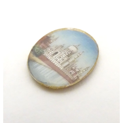 549 - A small cabochon depicting a miniature hand painted scene depicting the Taj Mahal. Approx. 3/4