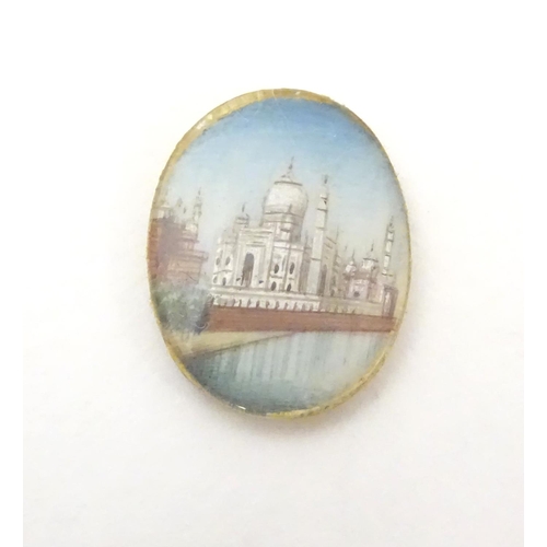 549 - A small cabochon depicting a miniature hand painted scene depicting the Taj Mahal. Approx. 3/4