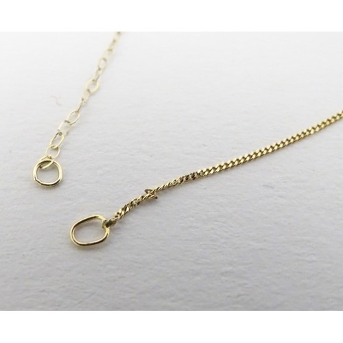 558 - A 9ct gold pendant and chain, the pendant set with turquoise cabochon, together with a 9ct gold chai... 