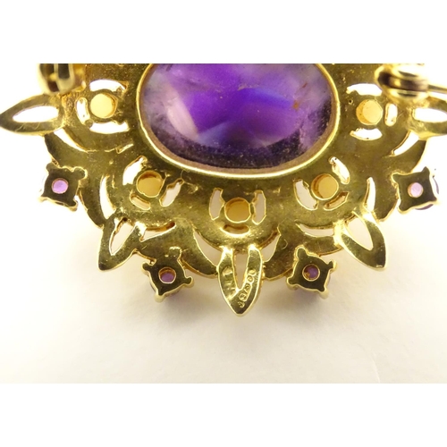 580 - A 9ct gold brooch set with central oval cabochon amethyst surrounded by eight seed
pearls, further s... 