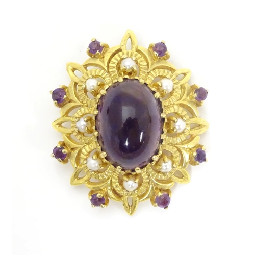 580 - A 9ct gold brooch set with central oval cabochon amethyst surrounded by eight seed
pearls, further s... 