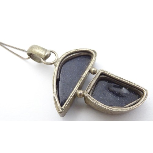 605 - A modernist pendant set with polished hardstone detail 2'' long with a 16'' silver chain.