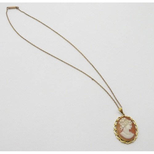 606 - A 9ct gold cameo pendant on a gilt metal chain. The pendant 1 1/2'' long