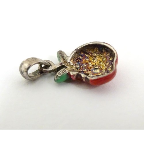 607 - A silver pendant / charm formed as a bitten apple with enamel decoration. ¾'' long