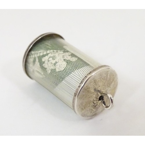 611 - A novelty pendant charm of cylindrical form and containing a £1 note. Approx 3 /4'' long