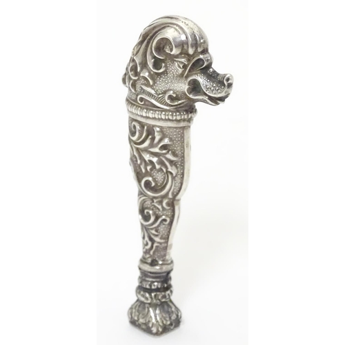 651 - A Continental white metal hand seal formed with stylised dog head decoration and seal under. Approx.... 