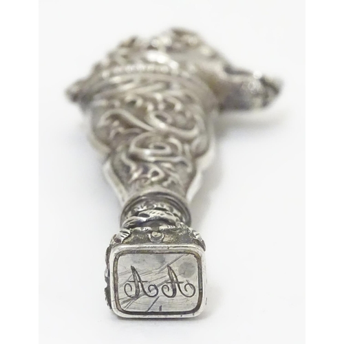 651 - A Continental white metal hand seal formed with stylised dog head decoration and seal under. Approx.... 