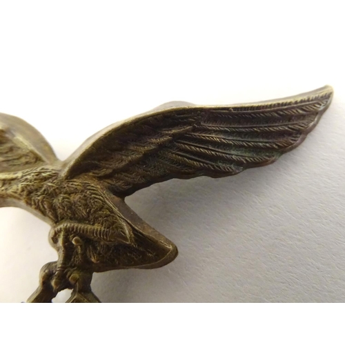 665 - Militaria: a WWII / WW2 / Second World War Luftwaffe metal cap badge, 2 5/8