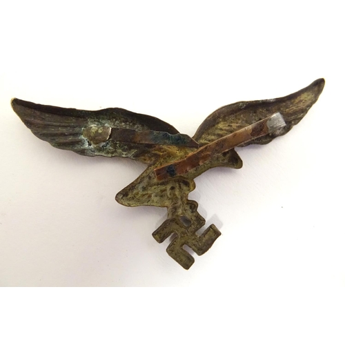 665 - Militaria: a WWII / WW2 / Second World War Luftwaffe metal cap badge, 2 5/8