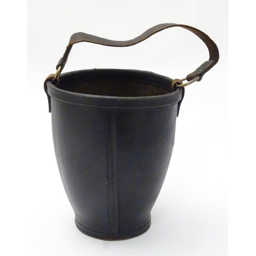 670 - A leather fire bucket with traces of polychrome decoration of the Royal coat of arms. Impressed Made... 