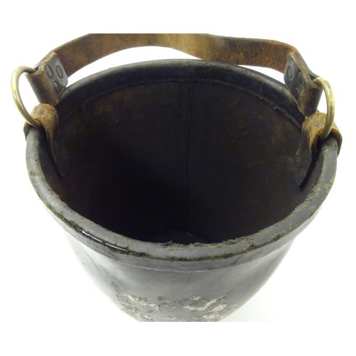 670 - A leather fire bucket with traces of polychrome decoration of the Royal coat of arms. Impressed Made... 