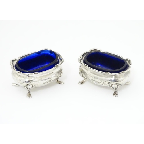 250 - A pair of silver salts with blue glass liners, hallmarked Sheffield 1908 maker Walker & Hall.  2 1/2... 