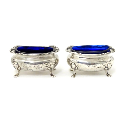 250 - A pair of silver salts with blue glass liners, hallmarked Sheffield 1908 maker Walker & Hall.  2 1/2... 