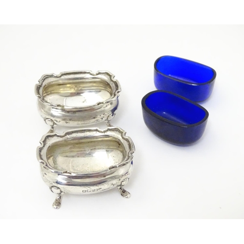 250 - A pair of silver salts with blue glass liners, hallmarked Sheffield 1908 maker Walker & Hall.  2 1/2... 