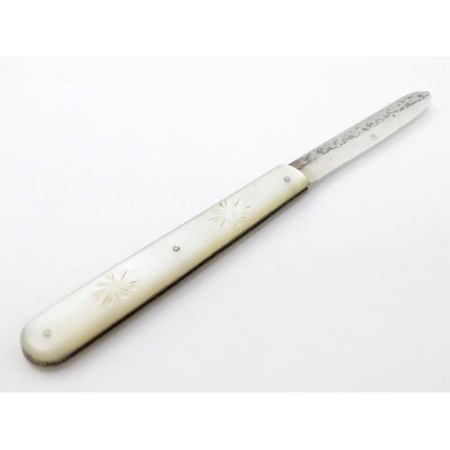 255 - A Victorian silver folding fruit knife with mother of pearl handle having engraved decoration. Hallm... 