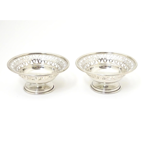 259 - A pair of silver pedestal bonbon dishes with pierced decoration. Hallmarked London 1966 maker A. Chi... 