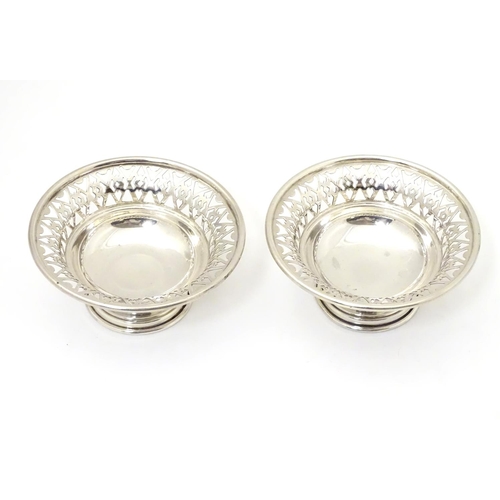 259 - A pair of silver pedestal bonbon dishes with pierced decoration. Hallmarked London 1966 maker A. Chi... 